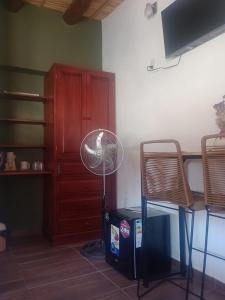 a fan in a room with a table and chairs at Ipay Alojamiento Familiar in Purmamarca