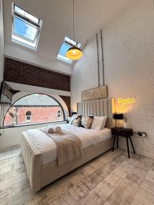 a bedroom with a large bed and a large window at Lux Stays - Luxury Apartment in Leeds City Centre near Canal in Leeds