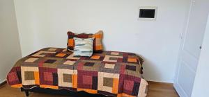 a bedroom with a bed with a colorful quilt at PINEROLO Apart in San Francisco