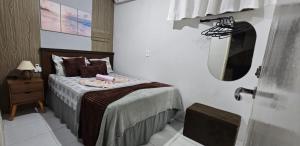 sypialnia z łóżkiem z lustrem na ścianie w obiekcie Casa em frente à praia em condominio w mieście Aracaju +11 zdjęć