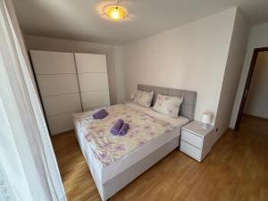 a bedroom with a bed with two pillows on it at Apartments by the sea Malinska, Krk - 19264 in Malinska