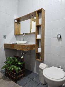 a bathroom with a toilet and a sink at Pousada Calu in Cunha +87 photos
