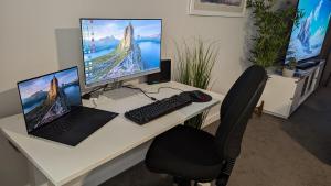 a desk with a computer and a laptop and a monitor at City Apartment 2xfree parking - Pool - Gym Wi-Fi in Perth