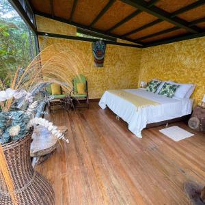 a bedroom with a bed and a table and chairs at ANCESTRAL GLAMPING in Barbosa