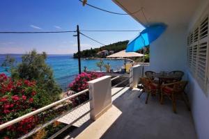 a balcony with a table and chairs and the ocean at Apartments by the sea Kukljica, Ugljan - 24177 in Kukljica