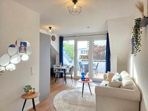 a living room with a couch and a table at Design-Apartments I Klimaanlage I Boxspring I Nespresso I Parklplatz in Weil am Rhein