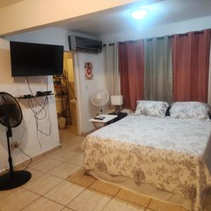 a bedroom with a bed and a flat screen tv at Cozy & comfortable crib in Carolina