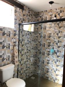 a bathroom with a toilet and a glass shower at Rancho Primor in Bemposta