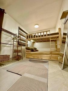 a room with two bunk beds and a ladder at Cozy Holiday Home in San Pablo City for Groups of 8-10 in Tiaong