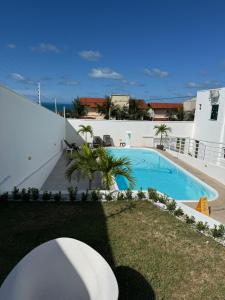 a swimming pool in the backyard of a house at Luxury Mansion in Porto das Dunas in Aquiraz