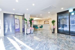 a lobby of a building with potted plants at Riverside in February Gyeongbuk Gyeongsan in Gyeongsan