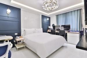 a bedroom with a large white bed and a desk at Riverside in February Gyeongbuk Gyeongsan in Gyeongsan +40 photos
