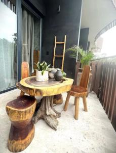a wooden table and two chairs and a wooden table and chairs at "Designer Cave Loft" in Tulum Hotel Zone - Beach Club included in Tulum