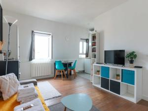 a living room with a couch and a table at Cosy studio 2P Montmartre - View of Sacré Coeur in Paris