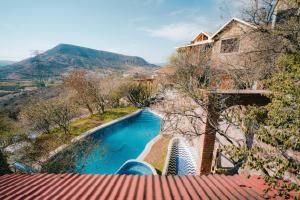 a view of a swimming pool from a house at Hotel Casa Cantera in El Carmen