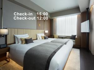 Postel nebo postele na pokoji v ubytování Mitsui Garden Hotel Roppongi Tokyo Premier
