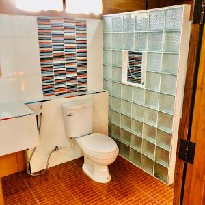 a bathroom with a white toilet and a window at Denchai City Resort เด่นชัยซิตี้ รีสอร์ท in Phrae +52 photos