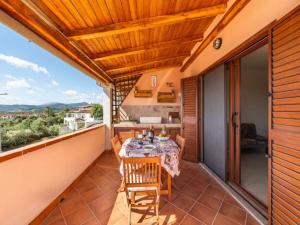 a patio with a table and chairs on a balcony at Apartment in Agrustos - Budoni with terrace in Porto Ottiolu +17 photos