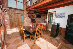 a dining room with a wooden table and chairs at Hotel Casa Cantera in El Carmen