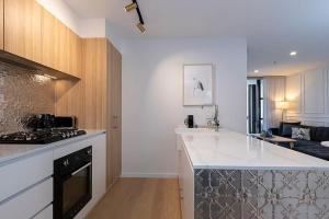 a kitchen with a stove and a counter top at 2 Bedroom Luxury & Style in the heart of Braddon 403 in Braddon