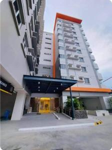 a large white building with a yellow door at The Cozy Nook Cebu in Cebu City