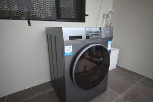 a washing machine sitting next to a wall at Nadi Vivi Apartments in Nadi