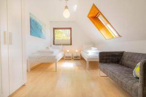 a living room with a couch and two beds at Wohnung-D-306 in Böhl