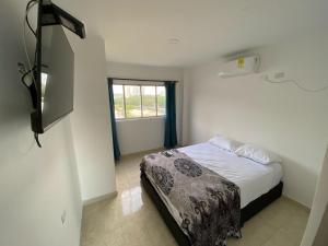 Ένα ή περισσότερα κρεβάτια σε δωμάτιο στο Hotel Villa Marta Cartagena