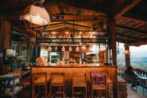 a bar in a restaurant with chairs around it at Hotel Casa Cantera in El Carmen