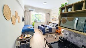 a living room with a couch and a tv at Flat Santos Dumont in Rio de Janeiro