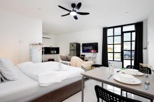 a bedroom with a bed and a dining room with a table at Casa Bella - Private Studio Ipoh - Pet allowed in Ipoh