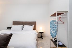 a bedroom with a large white bed and a table at Casa Bella - Private Studio Ipoh - Pet allowed in Ipoh