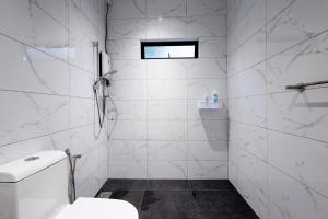 a white bathroom with a toilet and a window at Casa Bella - Private Studio Ipoh - Pet allowed in Ipoh +17 photos