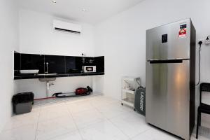 a kitchen with a stainless steel refrigerator and a sink at Casa Bella - Private Studio Ipoh - Pet allowed in Ipoh