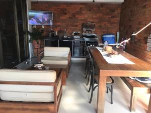 a kitchen with a table and chairs and a counter at Edifício Cajueiro Bessa in João Pessoa