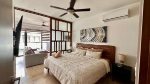 a bedroom with a bed and a ceiling fan at Ipana Luxury Suites By Caribe Rentas in Playa del Carmen +57 photos
