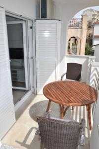 a wooden table and chairs on a balcony at House with Sea View in Drage