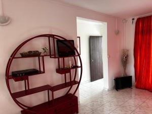 a room with a shelf with a tv and a mirror at Villa Ludger-Rose in Le Moule +22 photos