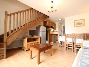 a kitchen and living room with a staircase and a table at Duplex 3 chambres pour 8 pers avec jolie vue village à Aussois - FR-1-508B-16 in Aussois