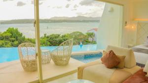 a living room with a view of the water at Yuki Suite Kourijima in Nakijin +177 photos