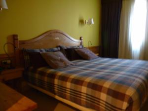 Ein Bett oder Betten in einem Zimmer der Unterkunft Petit Hotel