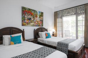 Postel nebo postele na pokoji v ubytování Sans Vibes Puri Mango Hotel Sanur