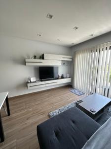 a living room with a couch and a tv at Brand New 2 Bedroom Apartment in Ħal Safi in Safi