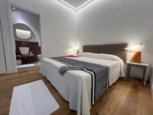 a bedroom with a large bed and a mirror at Dimora Elle in La Maddalena