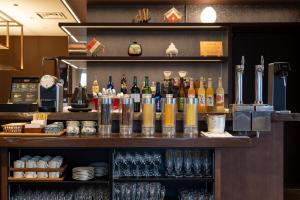a bar with bottles and glasses on a shelf at Setre Glover's House Nagasaki in Nagasaki +164 photos