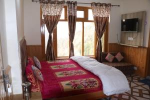 a bedroom with a bed and a window at Conara Resort Lake View in Shillong
