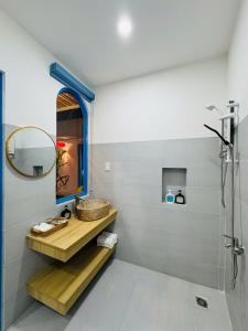 a bathroom with a sink and a mirror at MON House 2 in Ấp Sung Xuân +11 photos