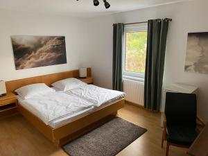 a bedroom with a bed and a window at Messeappartementhaus Bockenem direkt an der A7 in Bockenem