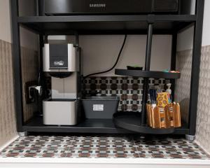 a kitchen with a coffee maker on a shelf at La Stella Del Pupo TEODORA in Fasano