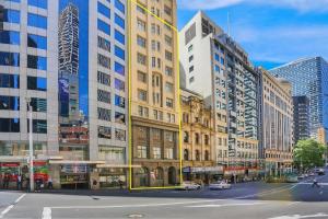 a city with tall buildings and a street with cars at CLDN4- Studio in Central Sydney CBD with Pool in Sydney +5 photos